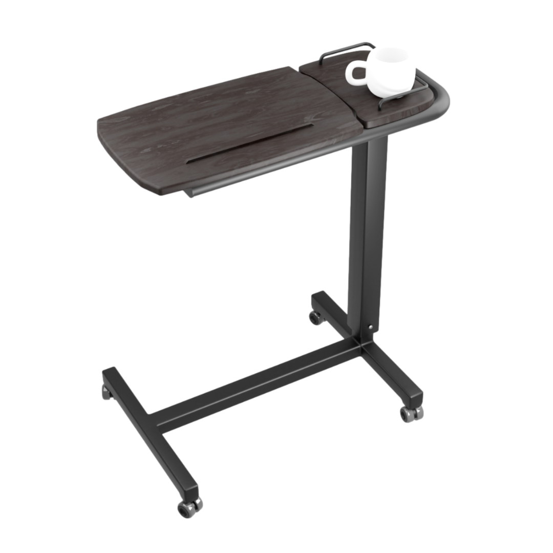 The iCare Medical Over Bed Tilting Table features a black frame, dark wood tilting tabletop, and height adjustment. Its T-shaped base with four wheels offers easy mobility and a multi-purpose surface for items like a coffee cup.